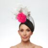 Black cap with polka dot and white feathers and hot pink rose