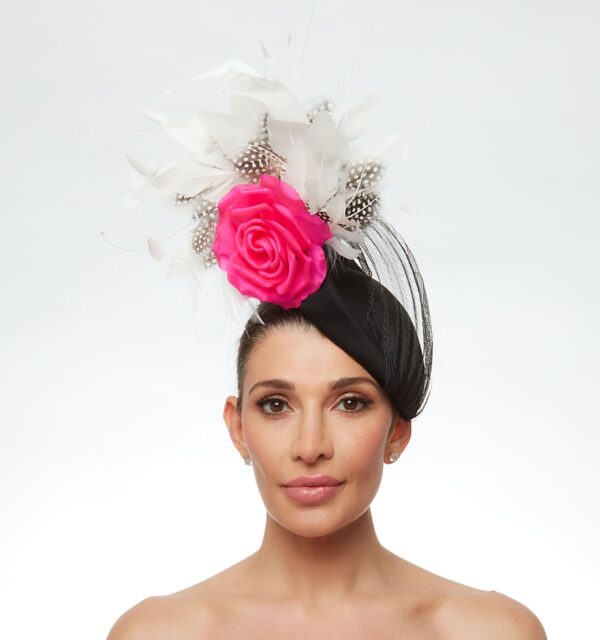 Black cap with polka dot and white feathers and hot pink rose