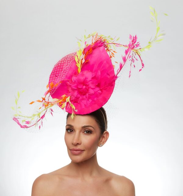 Hot pink oversized teardrop feather hat with neon yellow and orange feathers