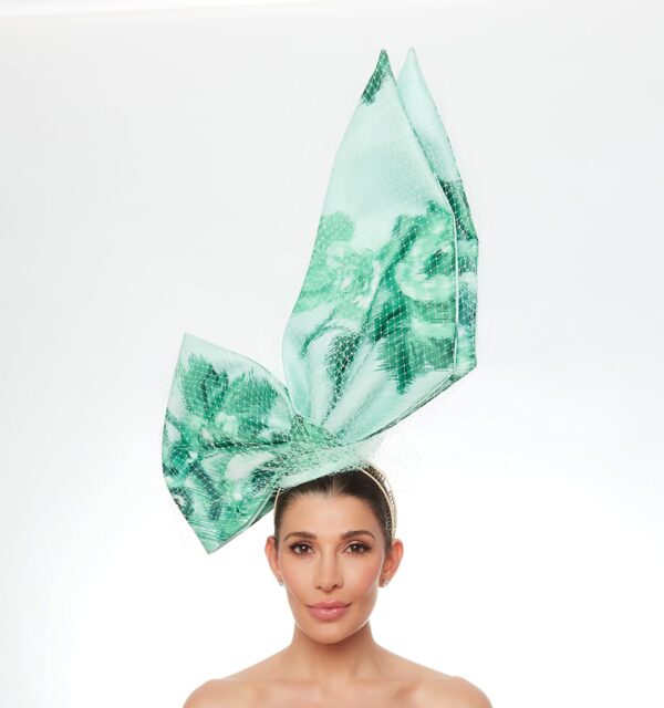 Green floral upright bow with white veiling